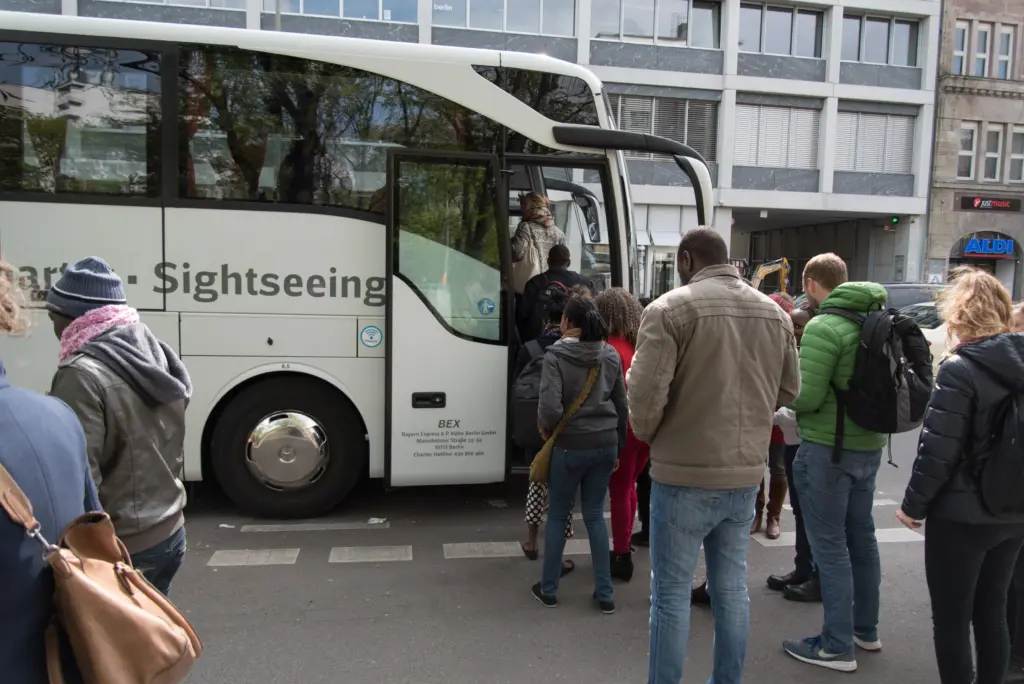 Menschen steigen in einen Reisebus. Foto: Jonas Walzberg